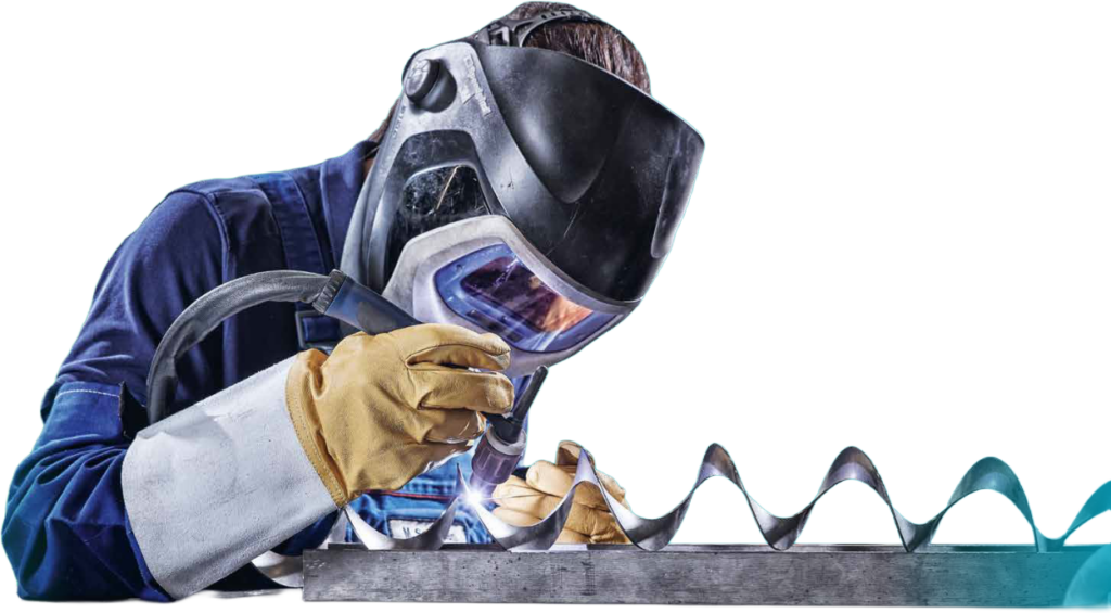 A welder wearing a protective mask works on a metal coil, MODUL69C RZ.