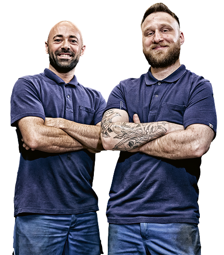 Two men in blue polo shirts with their arms crossed.