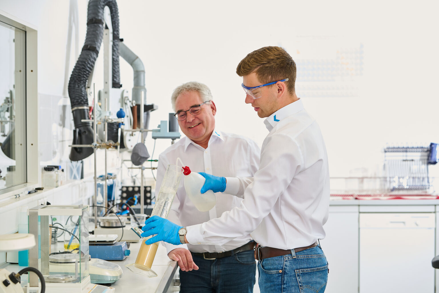 Two men in a laboratory working on a water treatment project.