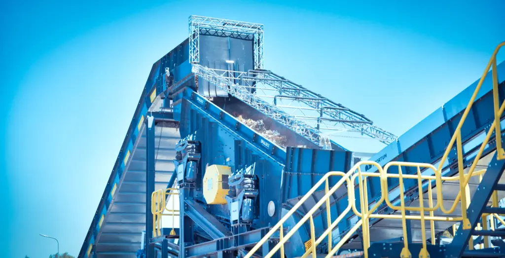 Industrial slag processing plant with conveyor belts.