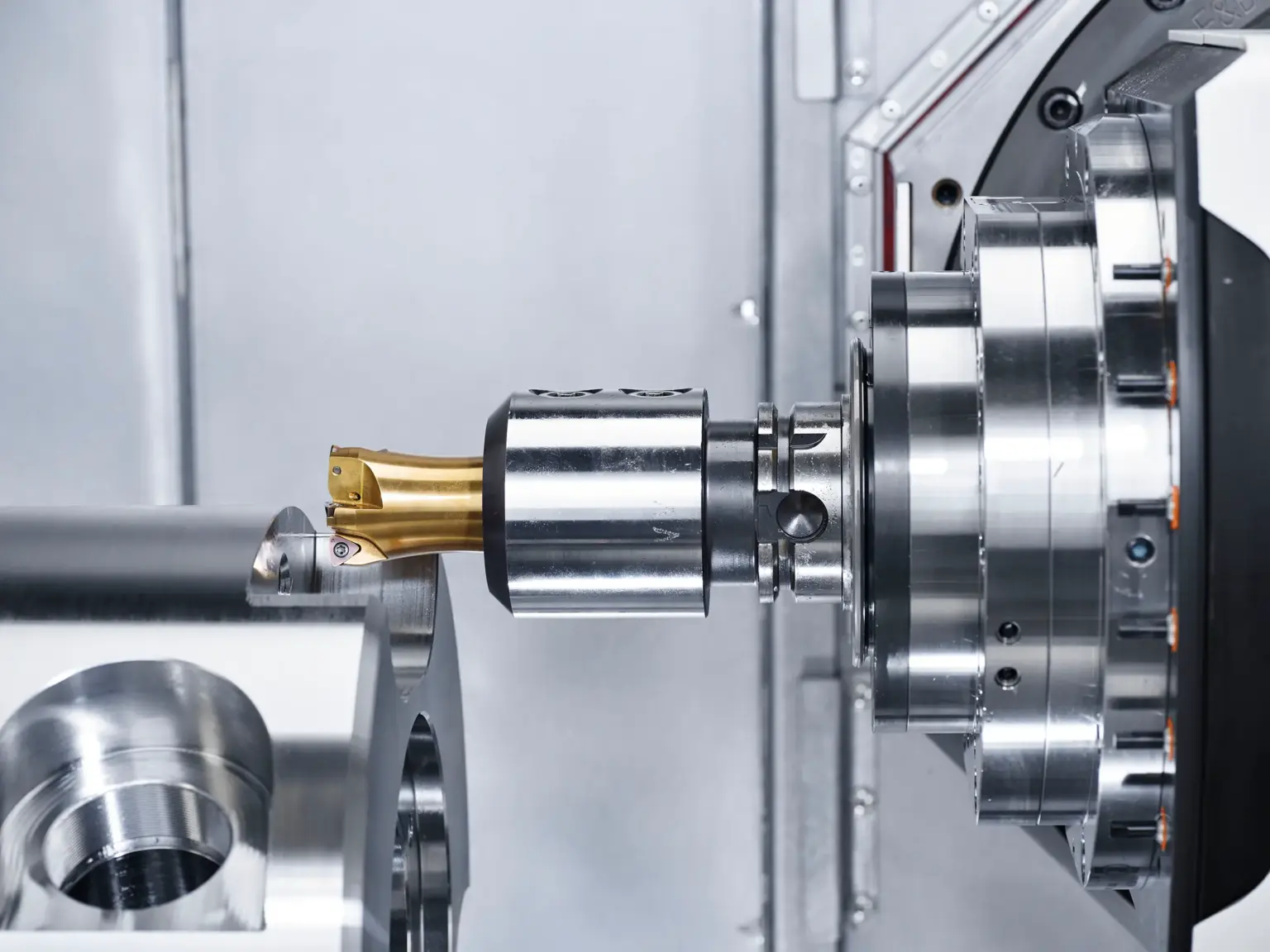 CNC machine machines metal components, with a focus on precision turned parts.