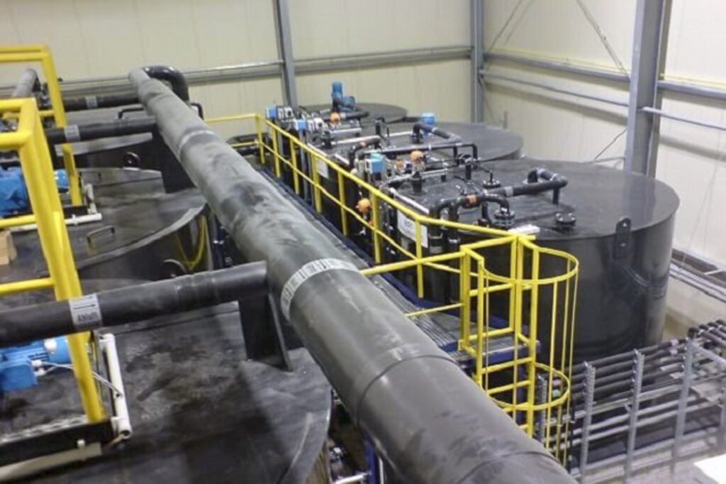Industrial plant for circulating water treatment with large tanks and piping.