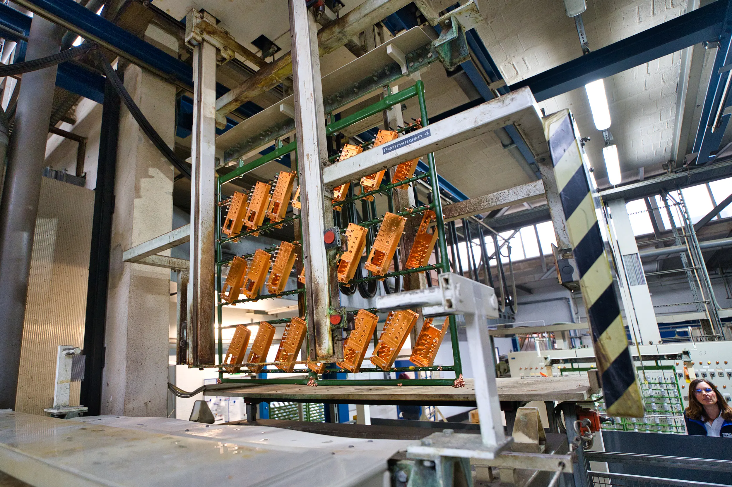 Industrial facility for the surface finishing of metal parts in a factory building.