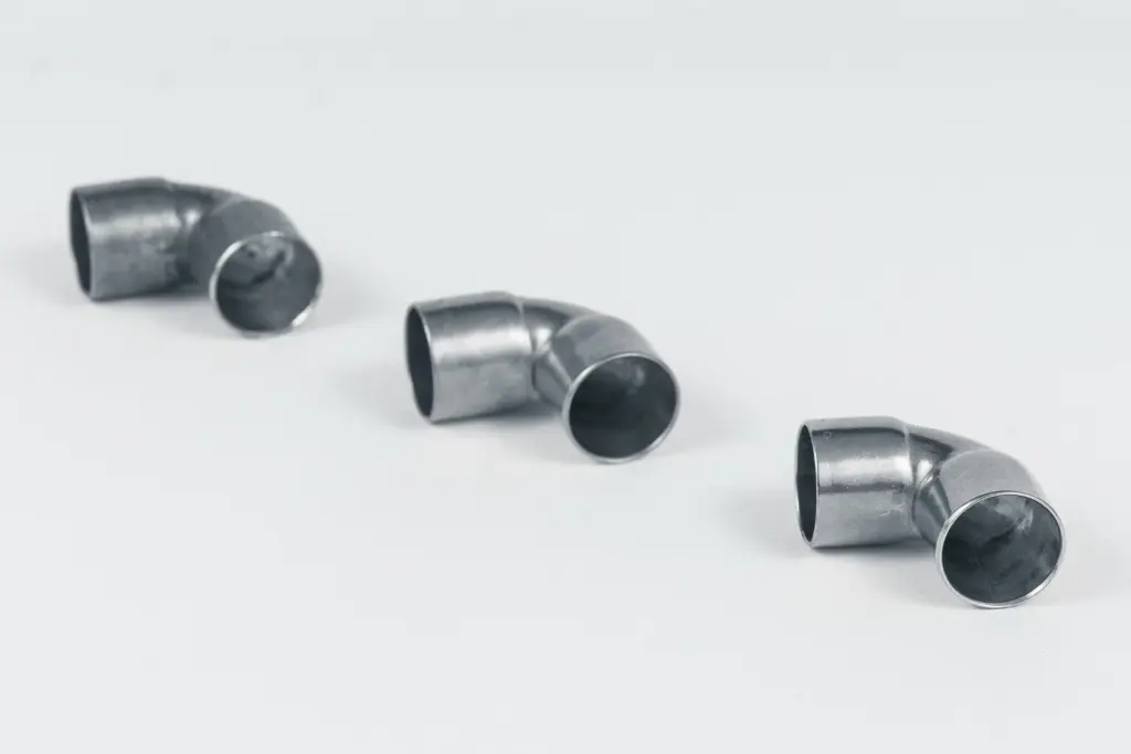 Three curved metal tubes on a white background.