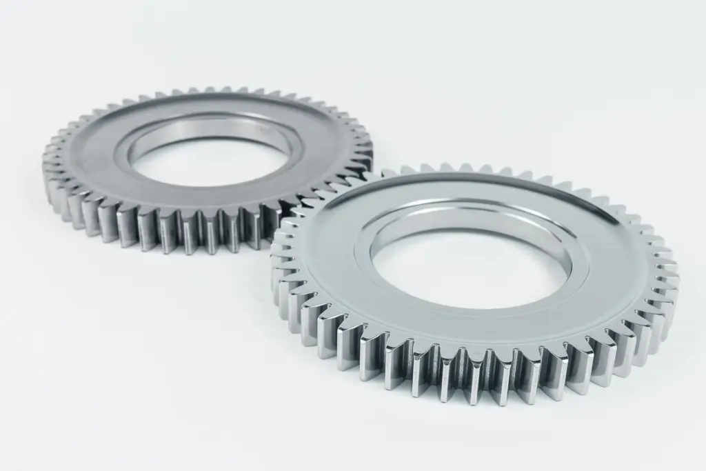 Two shiny gears on a white background.