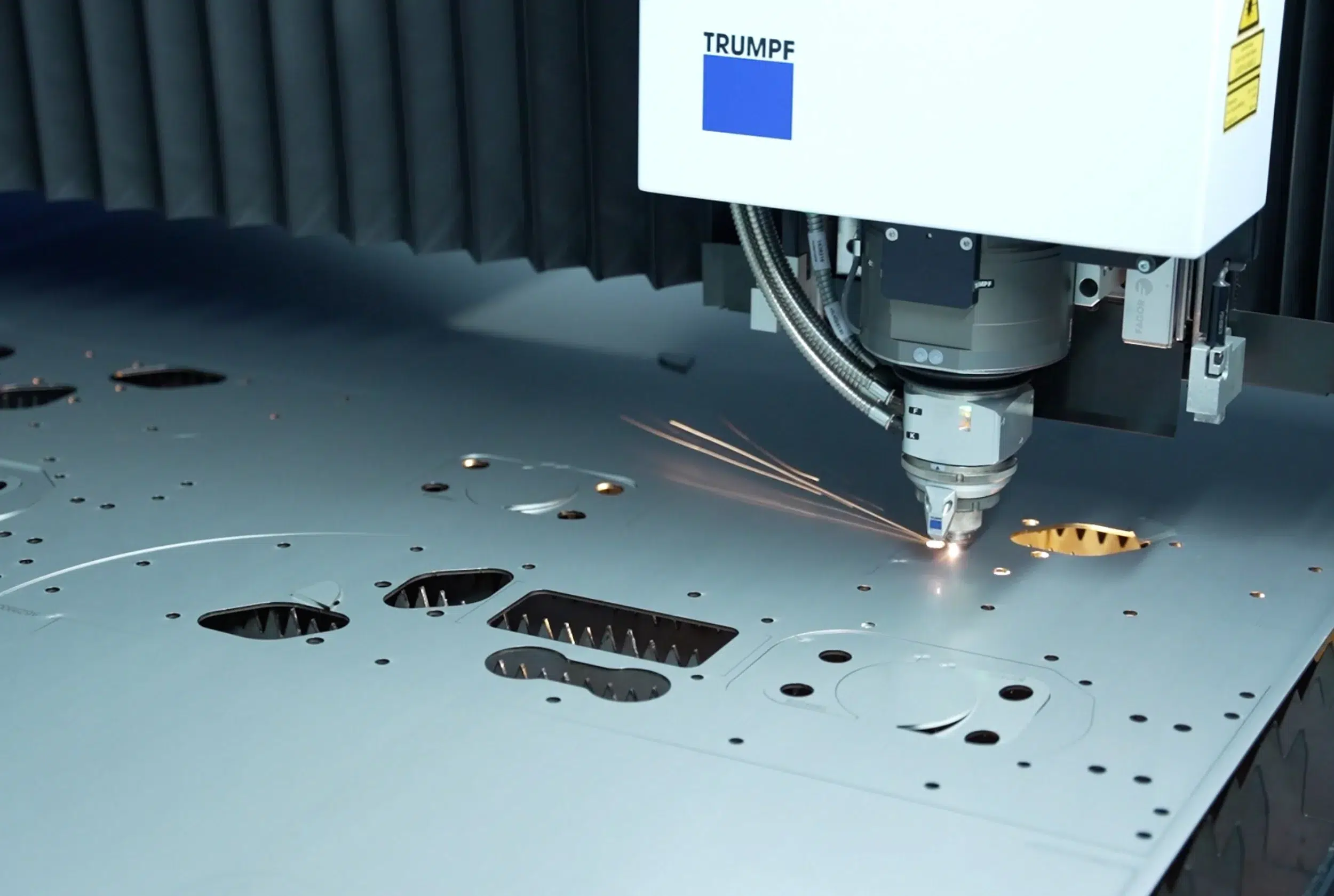 Close-up photo of a laser cutting process during the production of laser-cut parts using a laser cutting machine