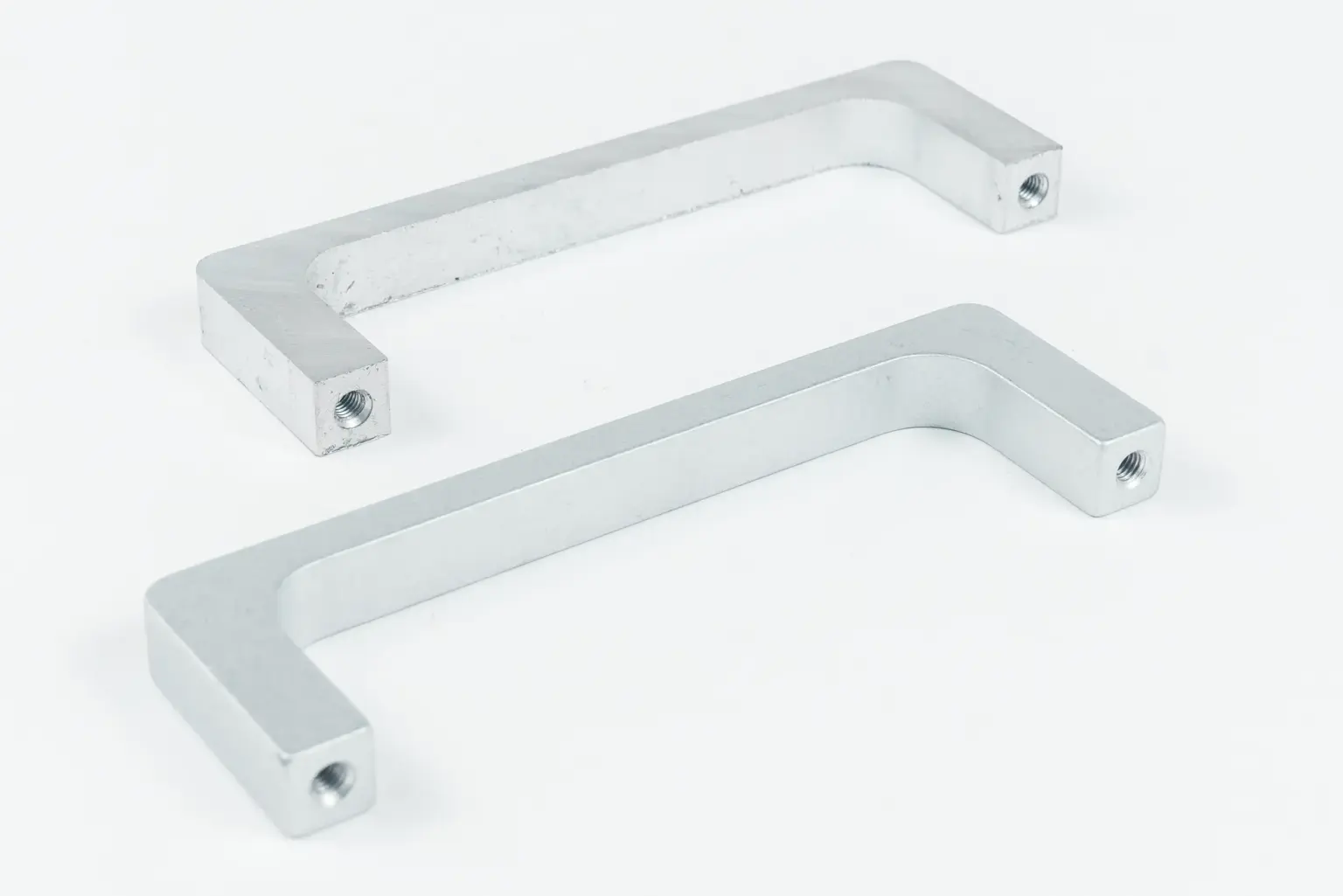 Two metal handles on a white background.