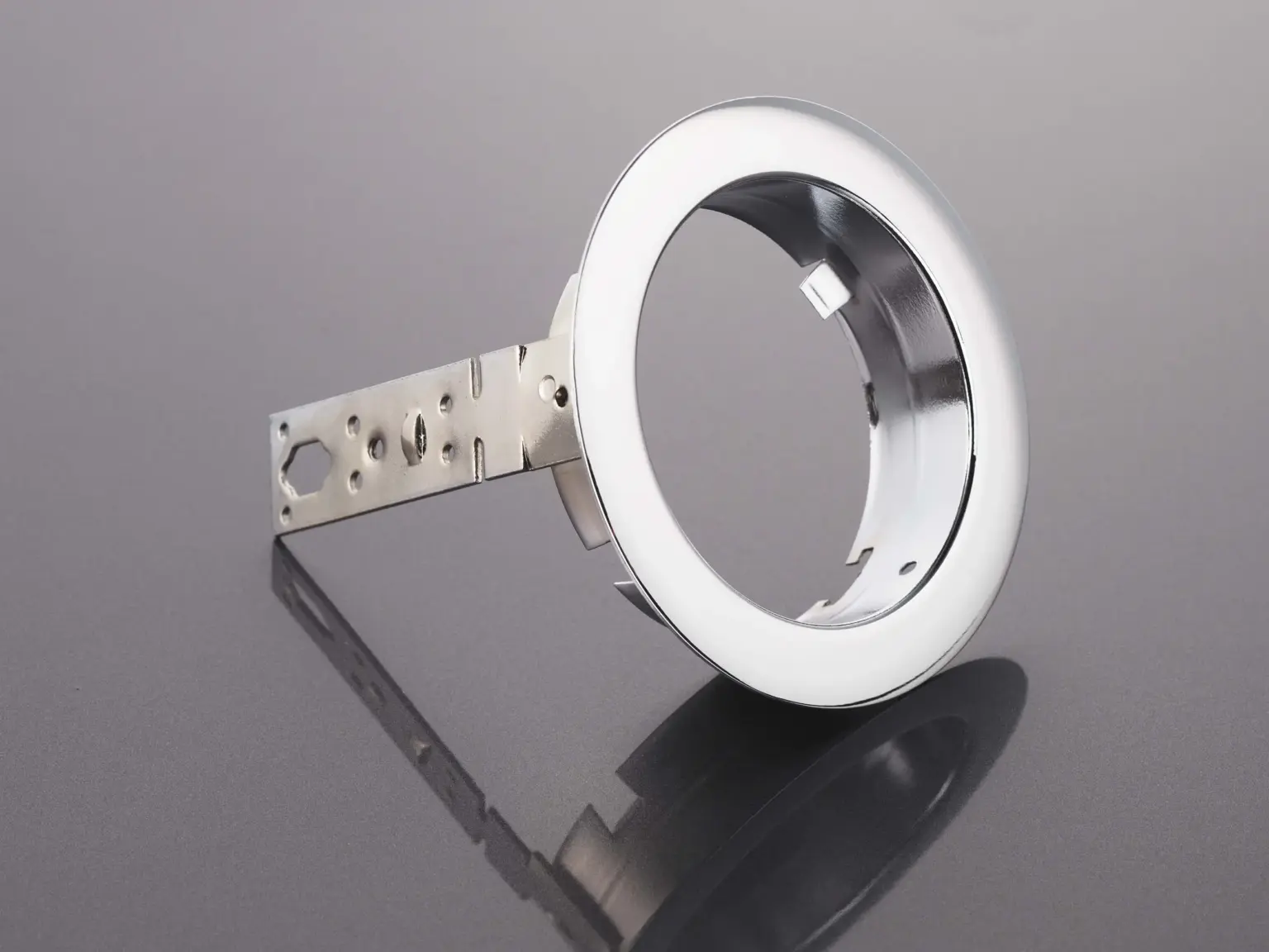 Metal component with a finished surface on a reflective substrate.