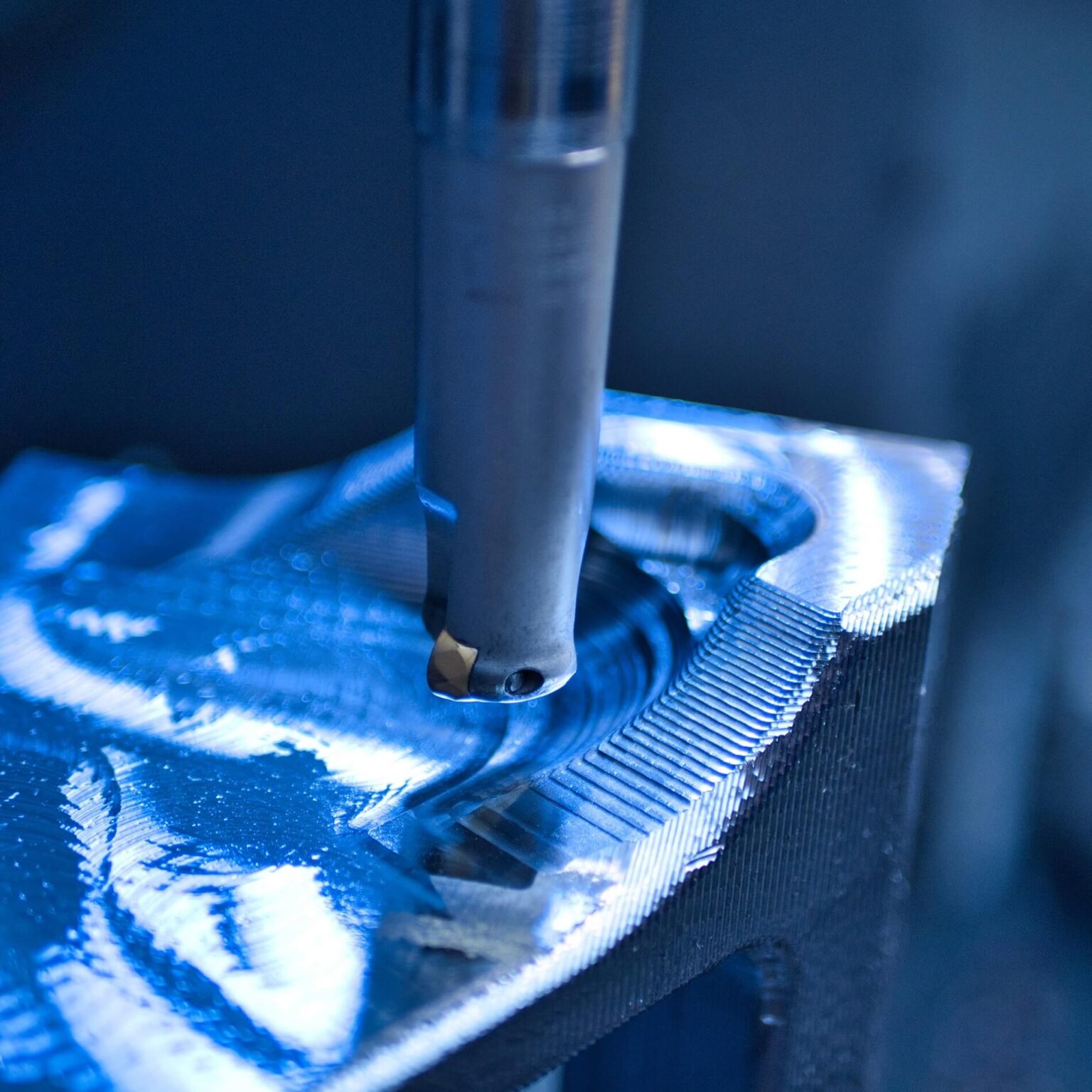 Detail view of a drill bit machining a CNC-milled part