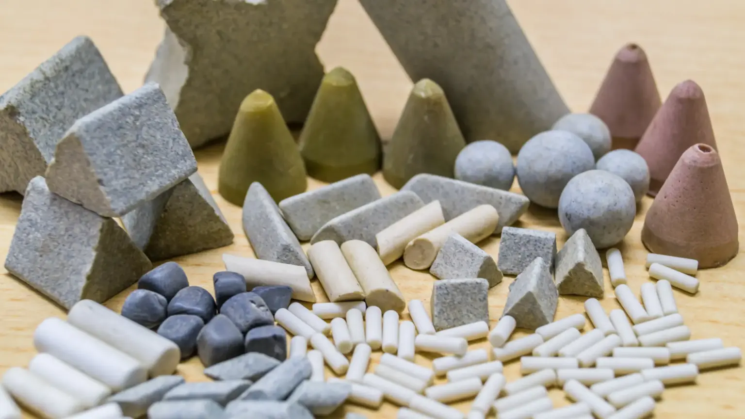 Various abrasive media for vibratory finishing of wood surfaces.
