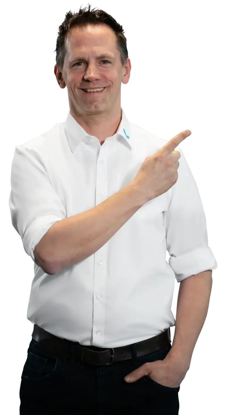 A man in a white shirt is smiling and pointing to the side.