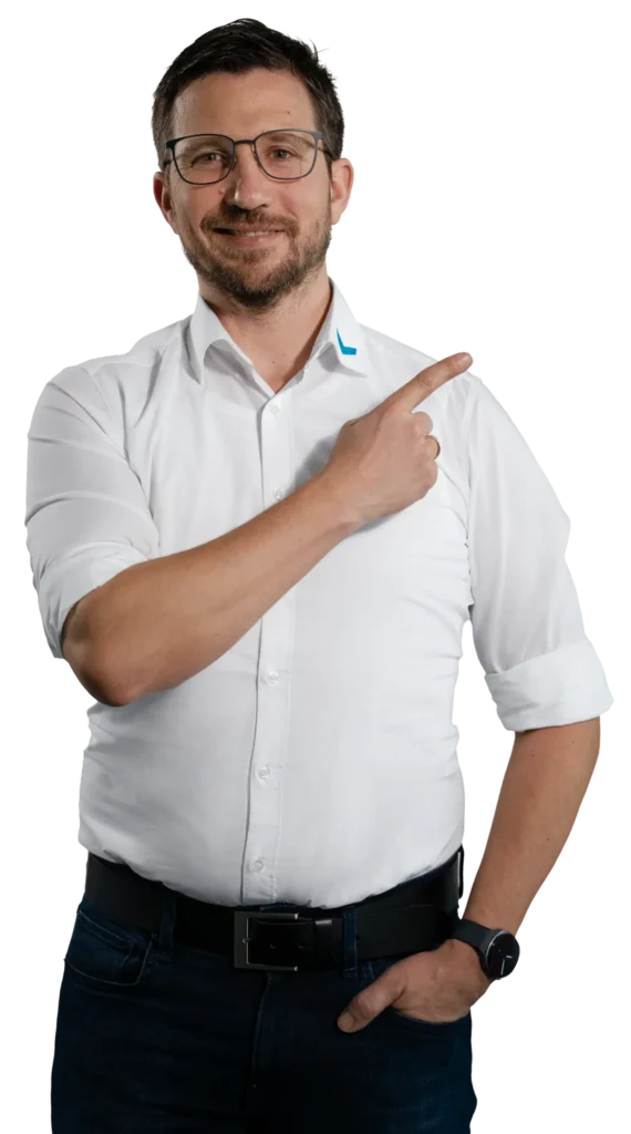A man in a white shirt is pointing to the right with his finger