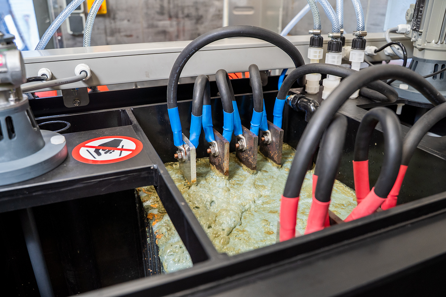 Close-up of an electrocoagulation system in operation. Shows the electric plates in the contaminated water.