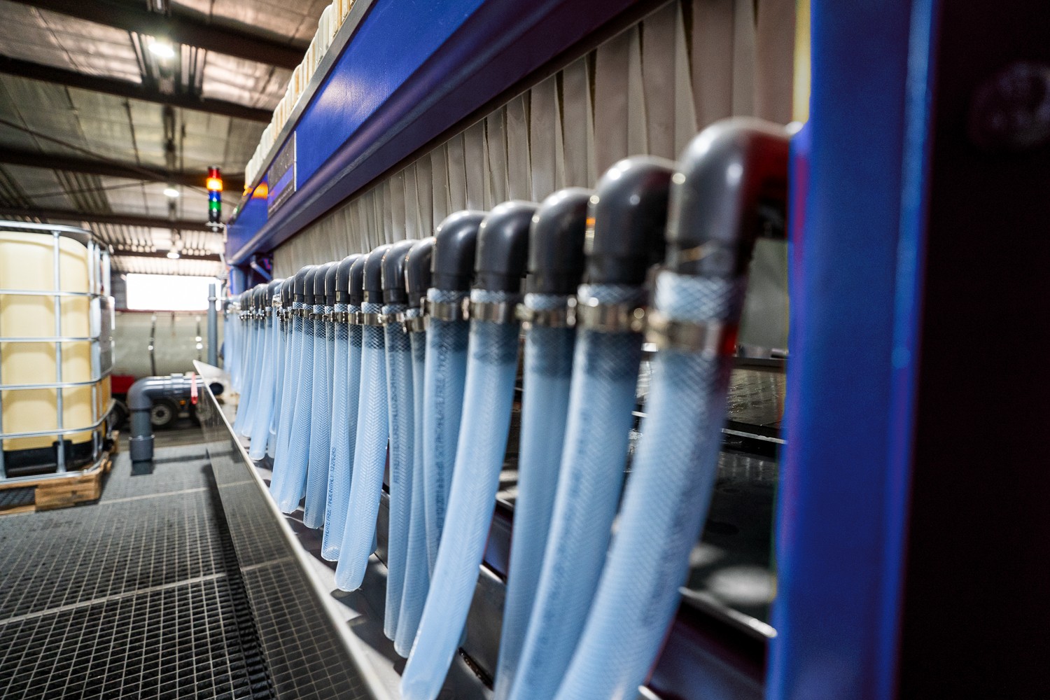 Close-up of hoses on a chamber filter press through which excess water drains