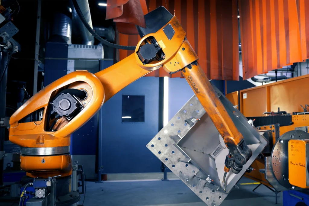 A welding robot is being used for the automated welding of a component for the rail vehicle industry. The photo was taken at SPALECK, a contract manufacturer and metalworking company.